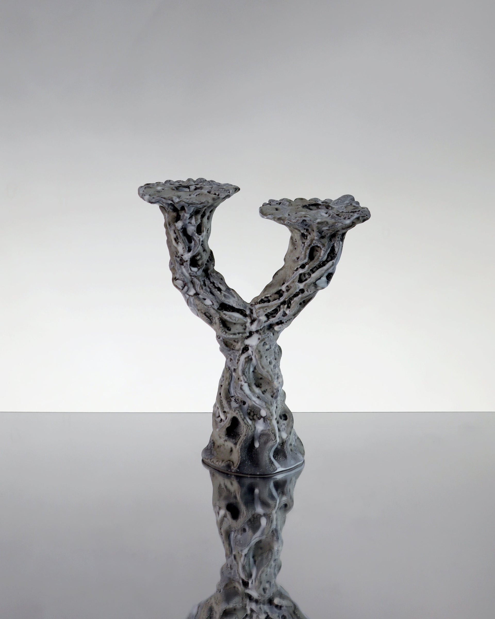 Hand made sculptural ceramic candle holder in a textured gray surrealist modern glaze. 